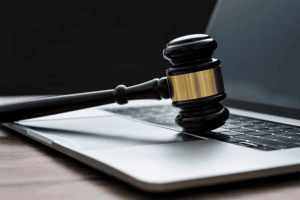 A legal gavel on a laptop, representing the process of a Korean brand applying for U.S. trademark registration online with the USPTO.