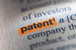 Patent definition highlighted in orange in a legal dictionary explaining intellectual property protection for business inventions