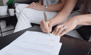 Inventor signing utility or design patent application agreement documents to secure intellectual property protection for a new product or invention