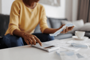 Entrepreneur reviewing trademark licensing revenue and brand valuation documents to assess economic benefits of registered trademark