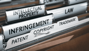 Legal file folders labeled infringement, trademark, copyright, and patent representing key defenses to trademark infringement claims in U.S. law