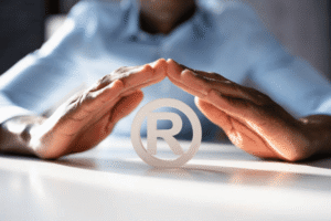 Business owner protecting registered trademark symbol representing legal defenses against trademark infringement claims in the U.S.
