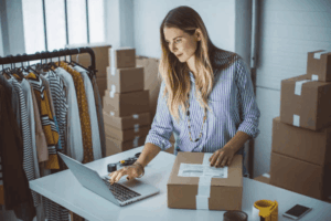 Female e-commerce seller managing branded clothing orders online highlighting the need for trademark protection strategies