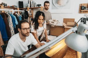 E-commerce business team reviewing trademark protection and brand strategy for their online clothing store