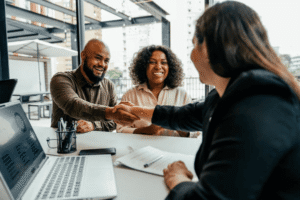Business buyers shaking hands with legal advisor after completing IP ownership verification and due diligence before acquiring a business