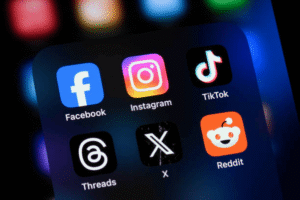 Social media apps on a smartphone, illustrating online trademark infringement, brand impersonation, and unauthorized use of trademarks on digital platforms.