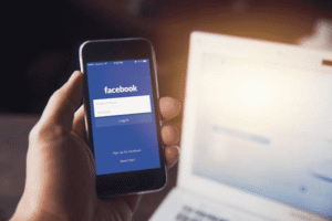 Business owner logging into Facebook social media platform highlighting the importance of trademarking social media handles and usernames for brand protection