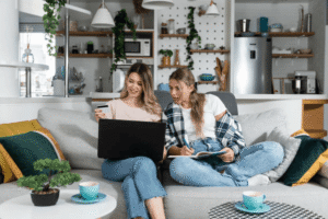 Two business owners reviewing legal documents and notes on laptop discussing what to do if someone copies their business idea