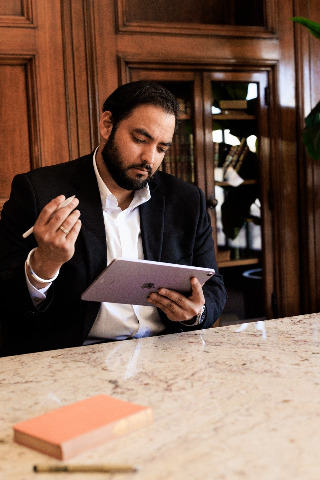 Drishti Law IPO attorney in Chicago Illinois reviewing initial public offering documents and intellectual property strategy on tablet for startup clients