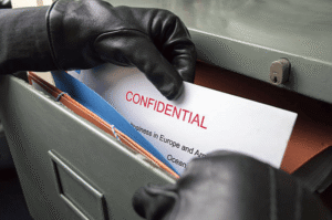 Confidential document being taken, representing trademark theft and unauthorized brand use.