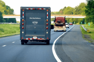 Amazon Prime one-day delivery truck on highway representing the importance of U.S. trademark registration for Amazon Brand Registry enrollment and e-commerce brand protection