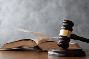 Legal gavel and open law book representing the TTAB trademark opposition process and federal trademark law governing Notice of Opposition proceedings